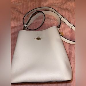 Small town bucket bag from Coach. Lightly used, pale pink with gold details.